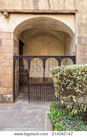 Embedded space with wooden balustrade and wooden arches behind a planted flower box at the external wall of an old historic house (Beit El sehemy) Cairo Egypt