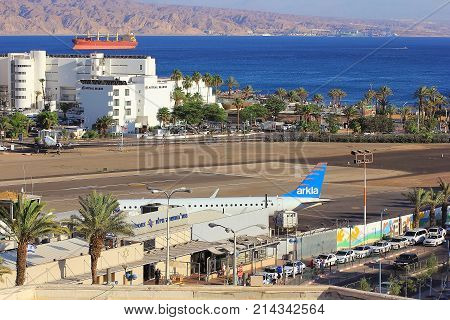 Eilat, Israel - MAY 24: plane of israeli airline Arkia, landed at the airport of Eilat on the background of luxurious hotels, Israel, on May 24, 2017 in  Eilat, Israel