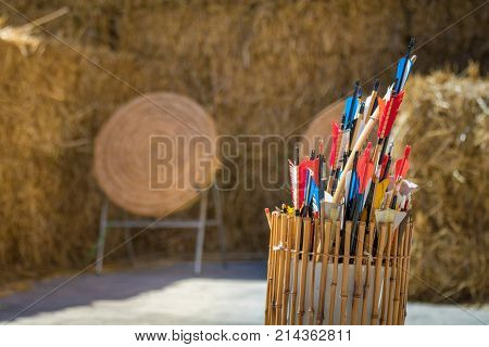 Quiver of traditional feathered arrows in front of traditional ancient medieval straw practice archery targets, Medieval Mdina, Malta, April 2017