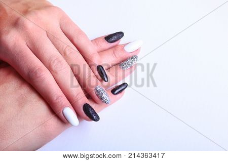 Black, white Nail art manicure. Holiday style bright Manicure with sparkles. Beauty hands. Stylish Nails, Nail Polish.