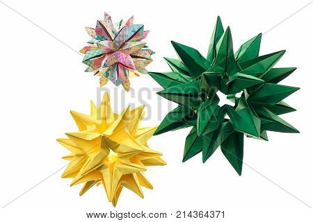 Three spiky origami decorations on white. Stars and cosmic bodies. Advanced level of paper folding art.