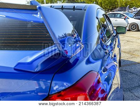 Blue Car With Reflective Paint In Parking Lot