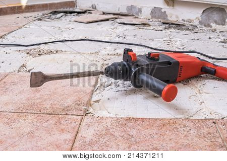 Removing Old Tiles. Jackhammer - Drilling Demolition Hammer On F