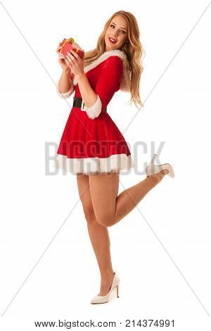 Full Length Portrait Of A Woman In Santa Calus Dress Holding A Present Isolated Over White Backgroun
