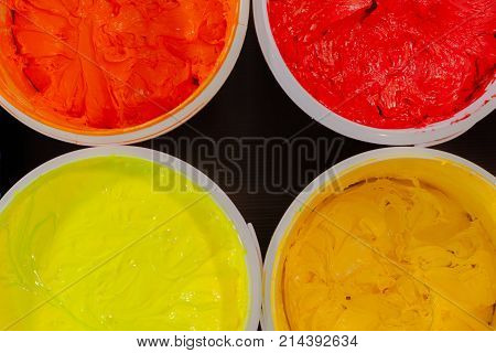 Top View Of Plastisol Ink In White Plastic Cans