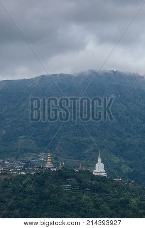 White big buddha aerial view with mountain background at Wat Prathat Phasornkaew Khao Kho Phetchabun Thailand