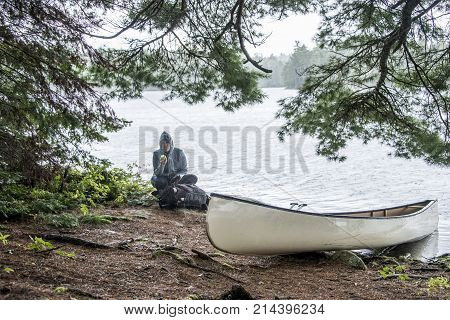 Rainy day in Canada Ontario Lake two rivers white blank Canoe Canoes parked on island in Algonquin National Park