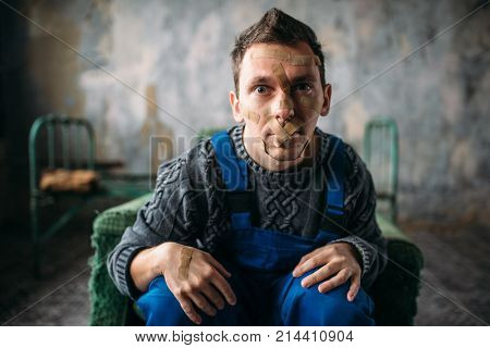 Madman, mouth sealed with plaster, psycho patient
