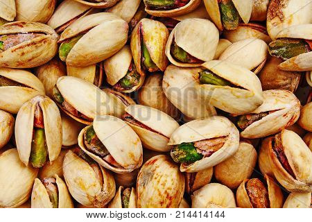 Pistachio texture. Nuts. Green fresh pistachios as texture. Roasted salted pistachio nuts healthy delicious food studio photo. Pattern.