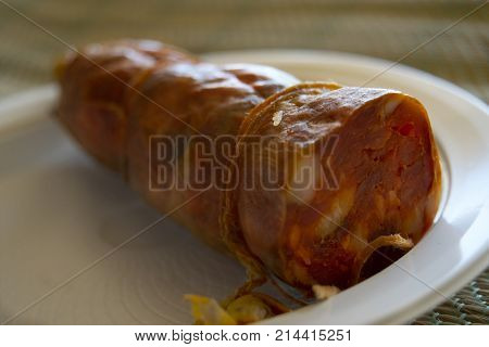 handmade calabrese soppressata on a white plastic dish