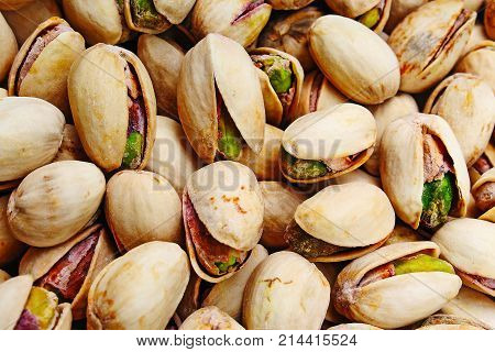 Pistachio texture. Nuts. Green fresh pistachios as texture. Roasted salted pistachio nuts healthy delicious food studio photo. Pattern.