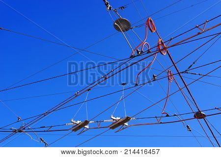 Streetcars or tram electric wires against the blue sky