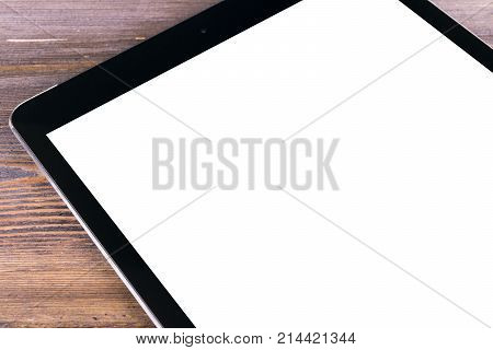 Tablet computer PC with blank screen mock up on black wooden table. Tablet computer isolated white screen. Tablet white screen with copy space. Empty space for text.