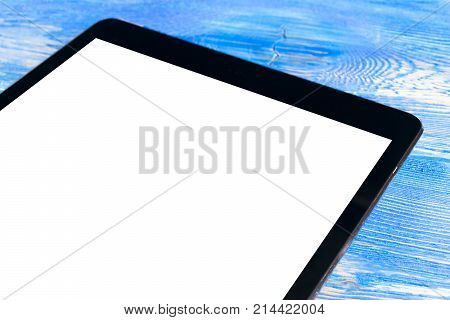 Tablet computer PC with blank screen mock up on black wooden table. Tablet computer isolated white screen. Tablet white screen with copy space. Empty space for text.