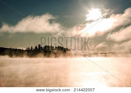 Lake of two rivers in algonquin national park ontario canada sunset sunrise with fog foggy mystical atmosphere background