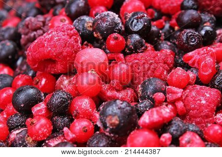Frozen mixed berries berry as background. Blueberries, raspberries black berries and currant mulberry texture pattern