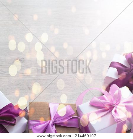Gift boxes decorated with satin ribbon. The festive lights. Top view flat lay. Square