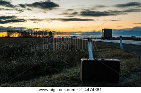 Autumn road home suitcase travel the road in the evening