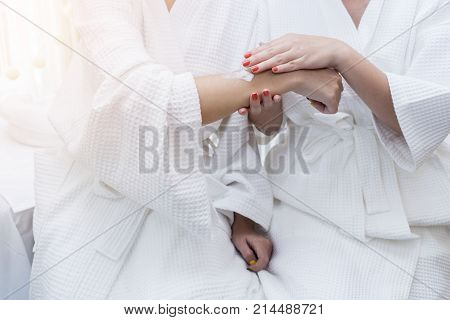Asian women applying skin-care products or Moisturizer to improve skin tone and texture in spa salon beauty concept