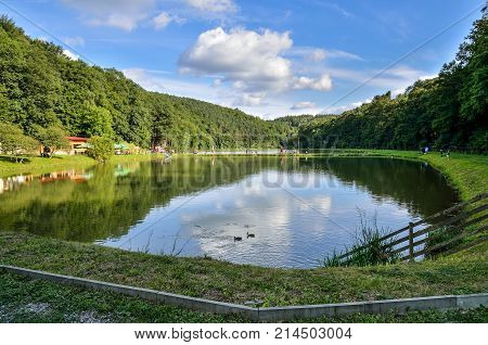 BEDKOWSKA VALLEY POLAND - AUGUST 13 2017: Tourists on the pond in the Bedkowska Valley Poland.