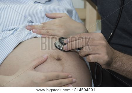 The man and pregnant woman are doing home activities.