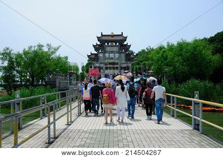 May 16 2015. Lake Tai Wuxi China. Chinese tourists entering through the TaiHu Xian Dao gate on three mount island in Lake Tai or taihu in Wuxi China in Jiangsu province. Taihu xian dao means Lake Tai Island.