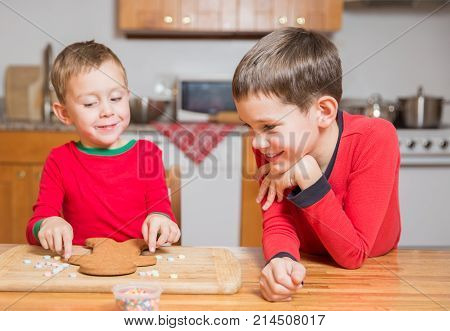 children decorate gingerbread man. the concept of family holiday and tradition. Christmas background.