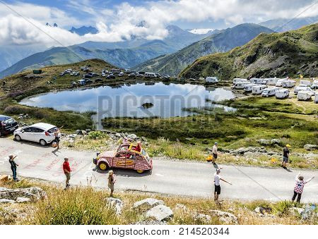 Col de la Croix de Fer France - 25 July 2015: Cochonou Caravan driving on the road to the Col de la Croix de Fer in Alps during the stage 20 of Le Tour de France 2015. Cochonou is an important French brand of short dry sausages.