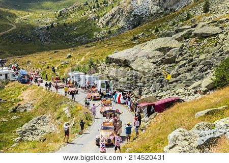 Col de la Croix de Fer France - 25 July 2015: Cochonou Caravan driving on the road to the Col de la Croix de Fer in Alps during the stage 20 of Le Tour de France 2015. Cochonou is an important French brand of short dry sausages.