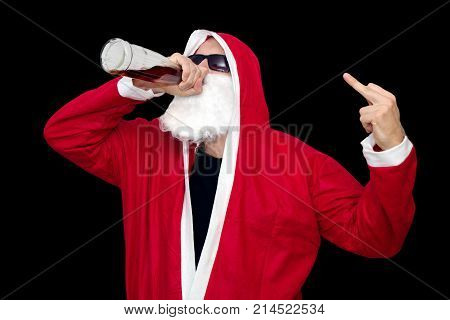 Bad Santa Claus with bottle of alcohol on black backround with middle finger up