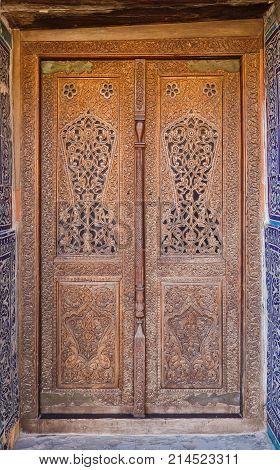 Ancient carved door with floral ornament traditional Uzbek craft Khiva Uzbekistan