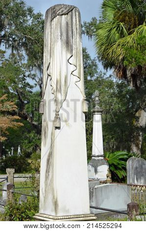 THUNDERBOLT, GA - October 8, 2017 A draped obelisk memorial rises above shorter tombstones at Bonaventure Cemeter.
