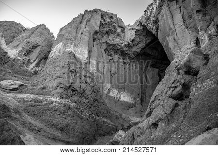 Black and white image of layered rock formation and cave at Palo Duro Canyon
