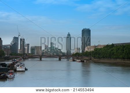 City cruise ships on the river Thames on background Lambert Bridge and London Towers in the morning London, England.