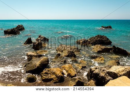 Dangerous rocks and reefs near beach in Pissouri bay Limassol district Cyprus