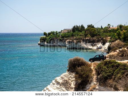 A four wheel drive car dangerously parked next to steep cliff at Governor's beach between Larnaca and Limassol Cyprus