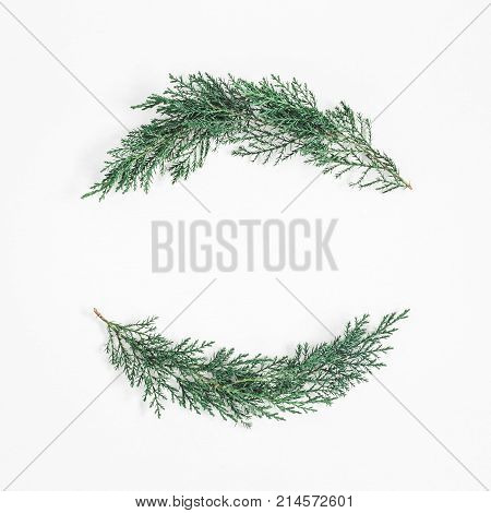 Christmas wreath made of cypress branches on white background. Christmas winter concept. Flat lay top view copy space square
