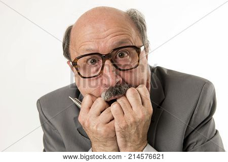 close up head portrait of bald 60s senior business man surprised and scared looking as if big mistake or disaster in the office isolated on white background