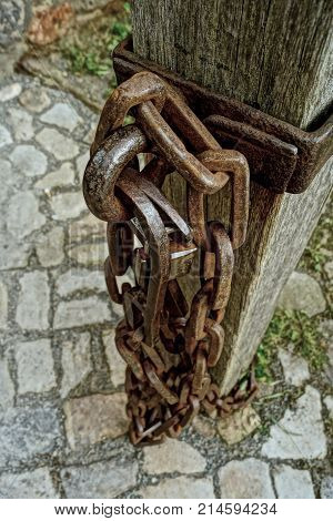 old iron chains hung from a pole