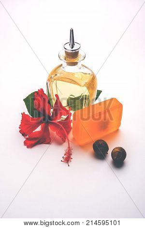 Jaswand or Hibiscus oil and bath soap/shampoo with flower and Reetha fruit and white towel
