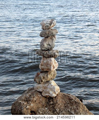 Stones balanced on the seashore doing yoga
