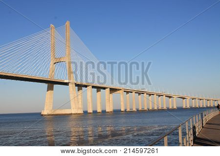 Panoramic photo of Vasco da Gama bridge in Lisbon on a sunny day.