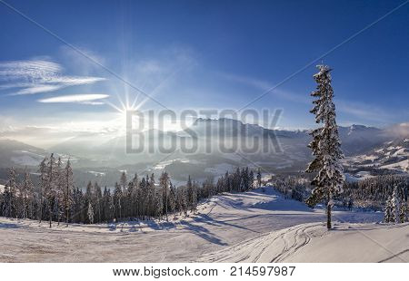 View from hut on mountain in skiresort Werfenweng to winter wonderland with sunset and Tennen mountains in Salzburg Austria