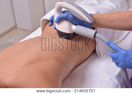 Young beautiful woman gets professional skin treatment in a beauty clinic. Body shaper