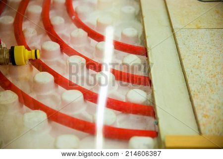 laying of pipes of a warm floor under a laminate of a parquet and a tile Floor heating pipe. Installation of engineering systems in a building.