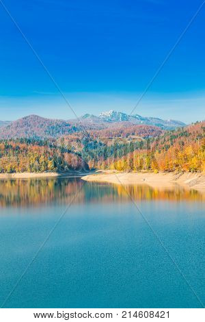 Panoramic view of Lokvarsko lake with Risnjak mountain in background, beautiful colorful mountain autumn landscape, Lokve, Gorski kotar, Croatia