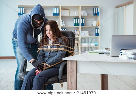 Criminal taking businesswoman as hostage in office