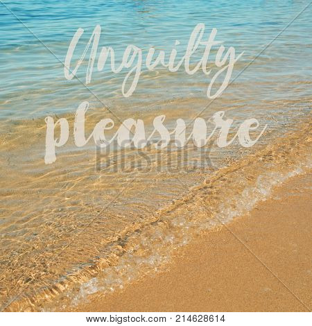 the text text unguilty pleasure over a quite beach with clear seawater