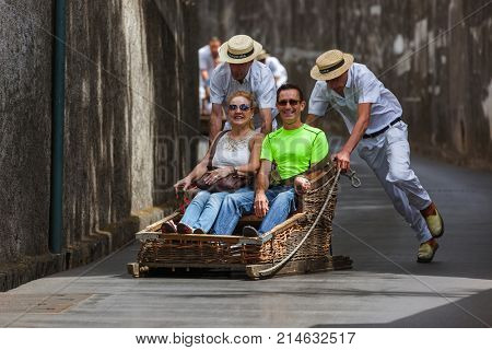 FUNCHAL, MADEIRA - SEPTEMBER 19: Traditional downhill sledge trip on September 19, 2016 in Madeira, Portugal.