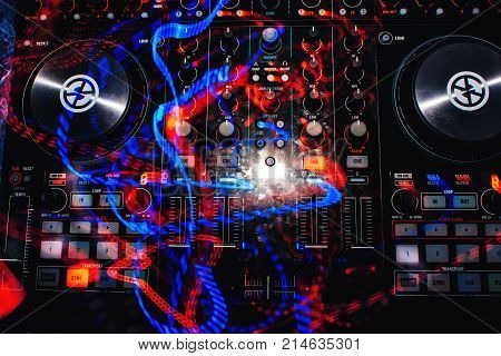 professional DJ Board with mixer for discs with multi-colored traces of light effects with long exposure
